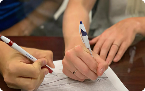 two people signing notary document